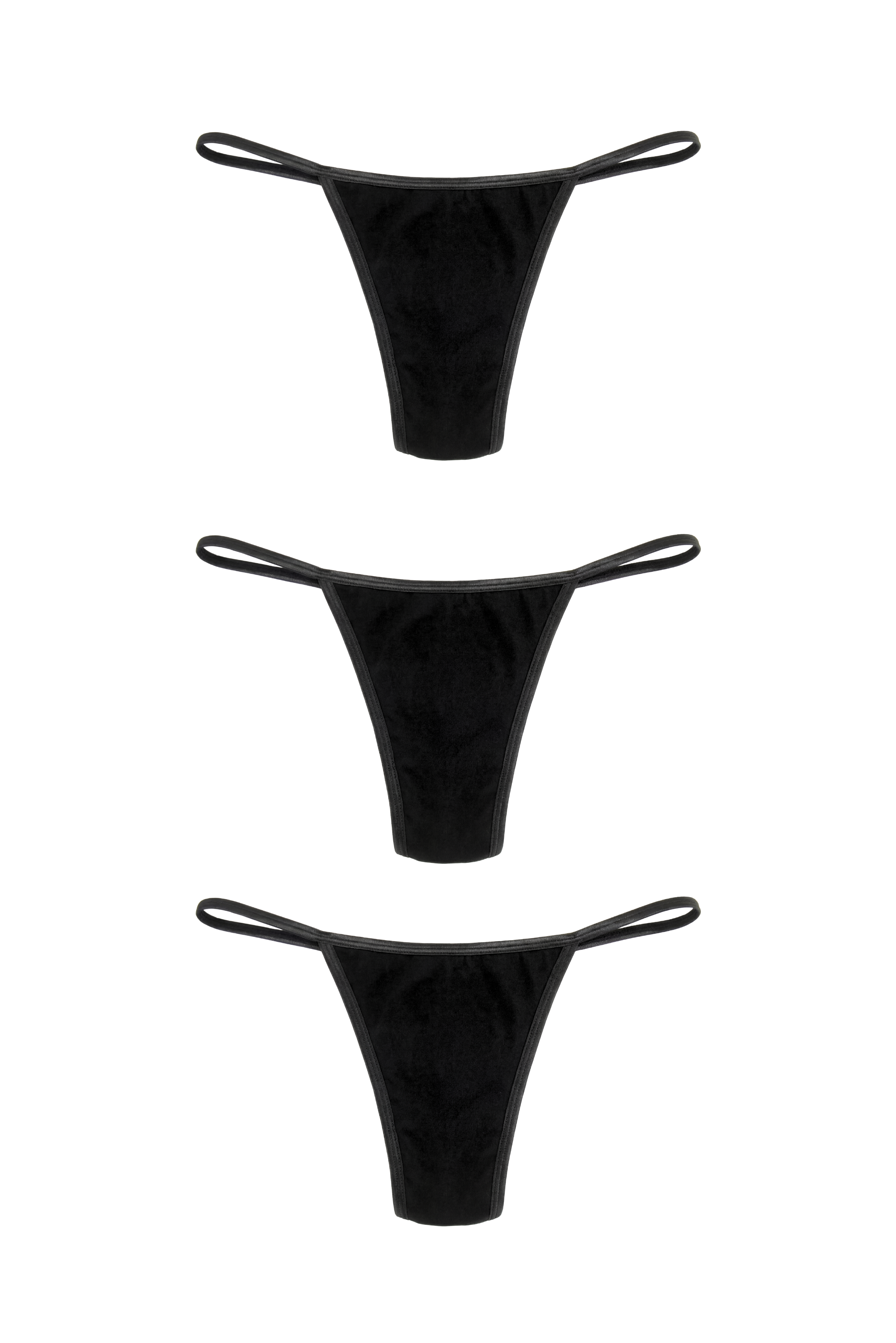 Three black g-strings stacked, flat lay