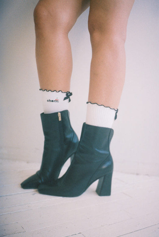 White Cherri Ruffle Trim socks styled with black ankle boots